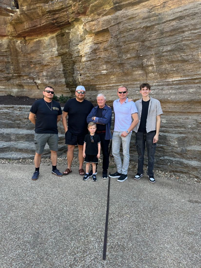 The Osenniy Family gathered in front of a sandstone bluff